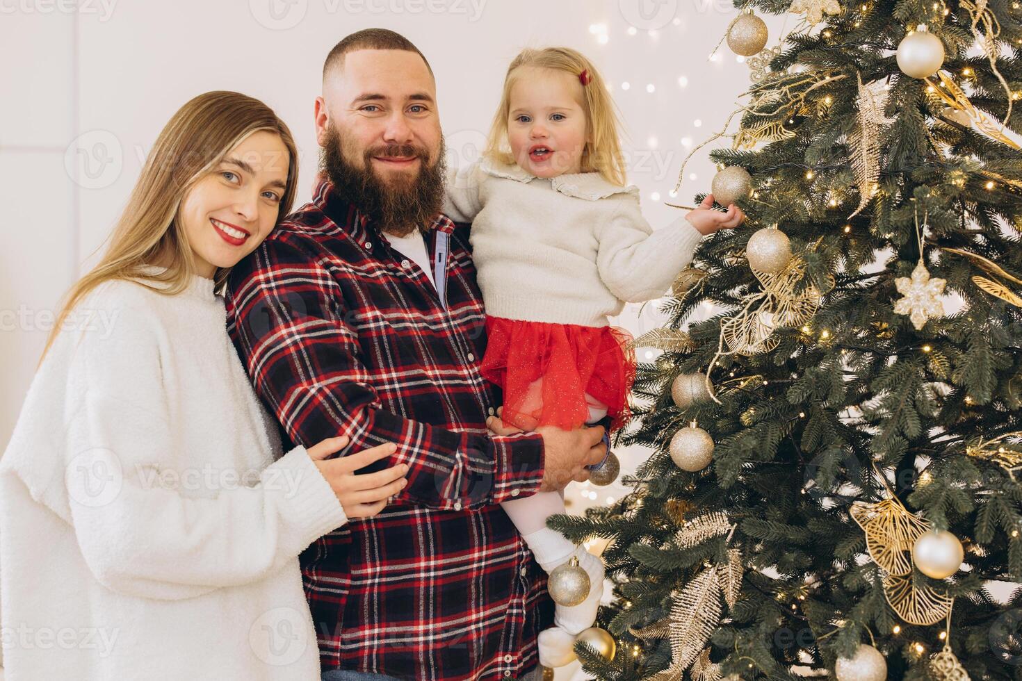 Family decorating christmas tree together at home photo