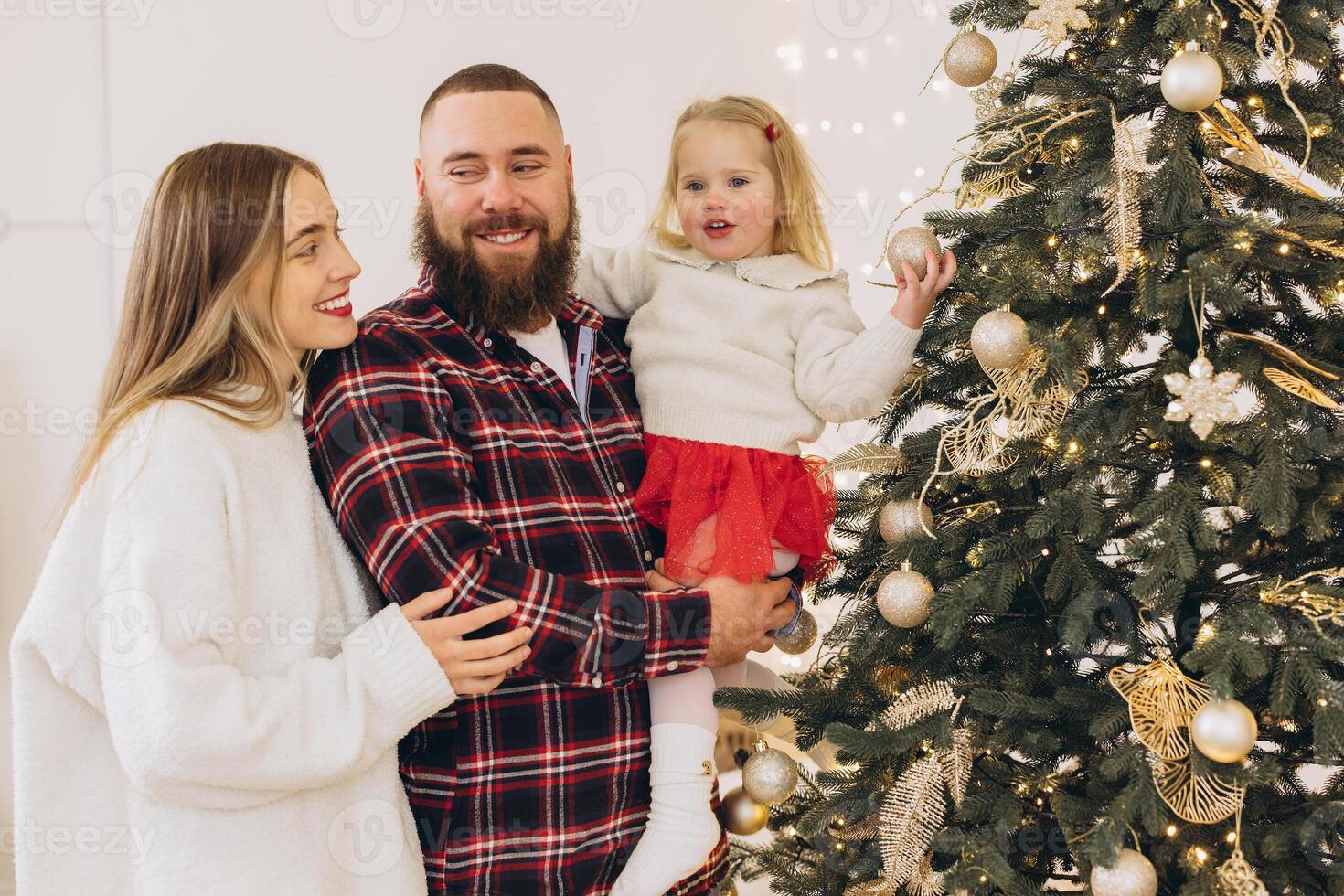Family decorating christmas tree together at home photo