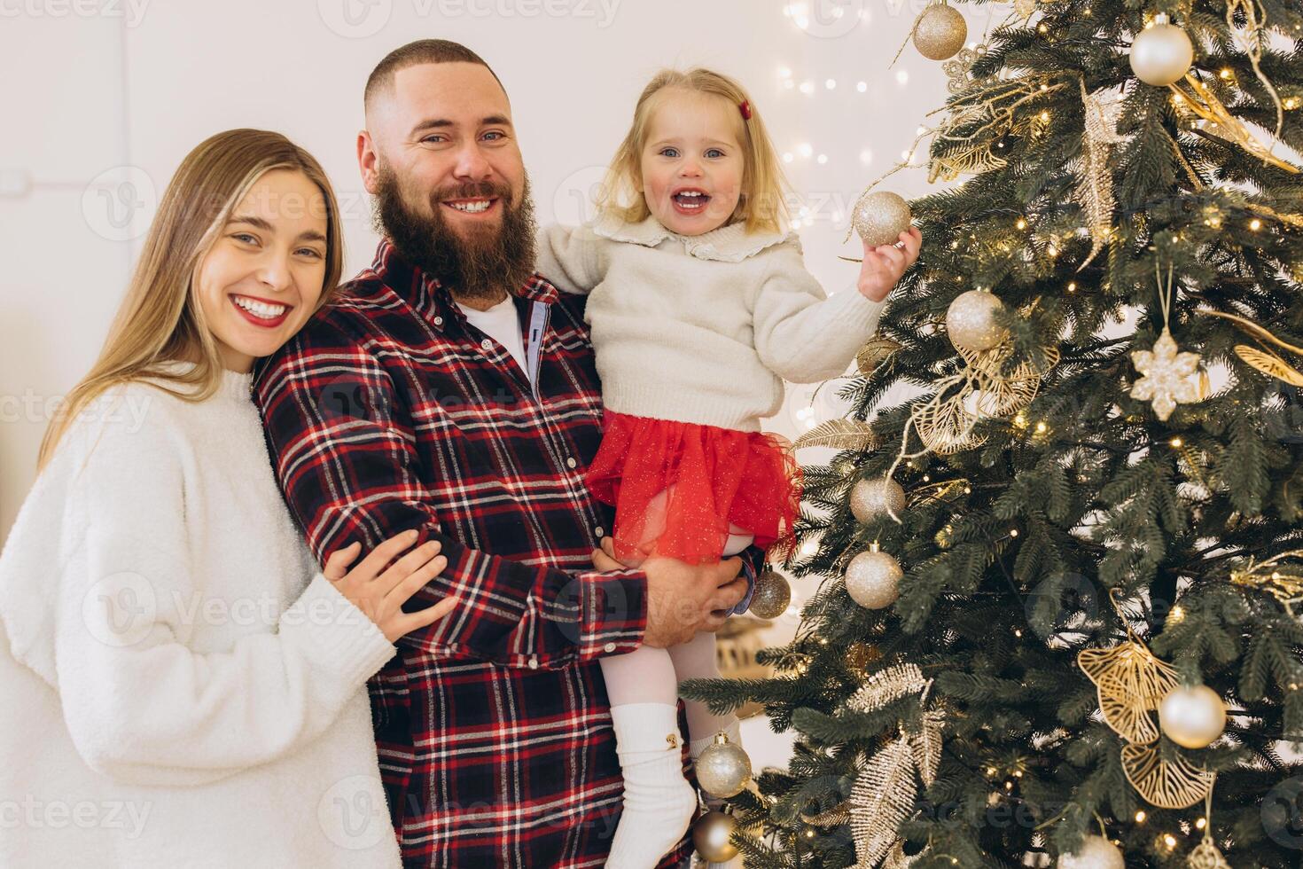 Family decorating christmas tree at home photo