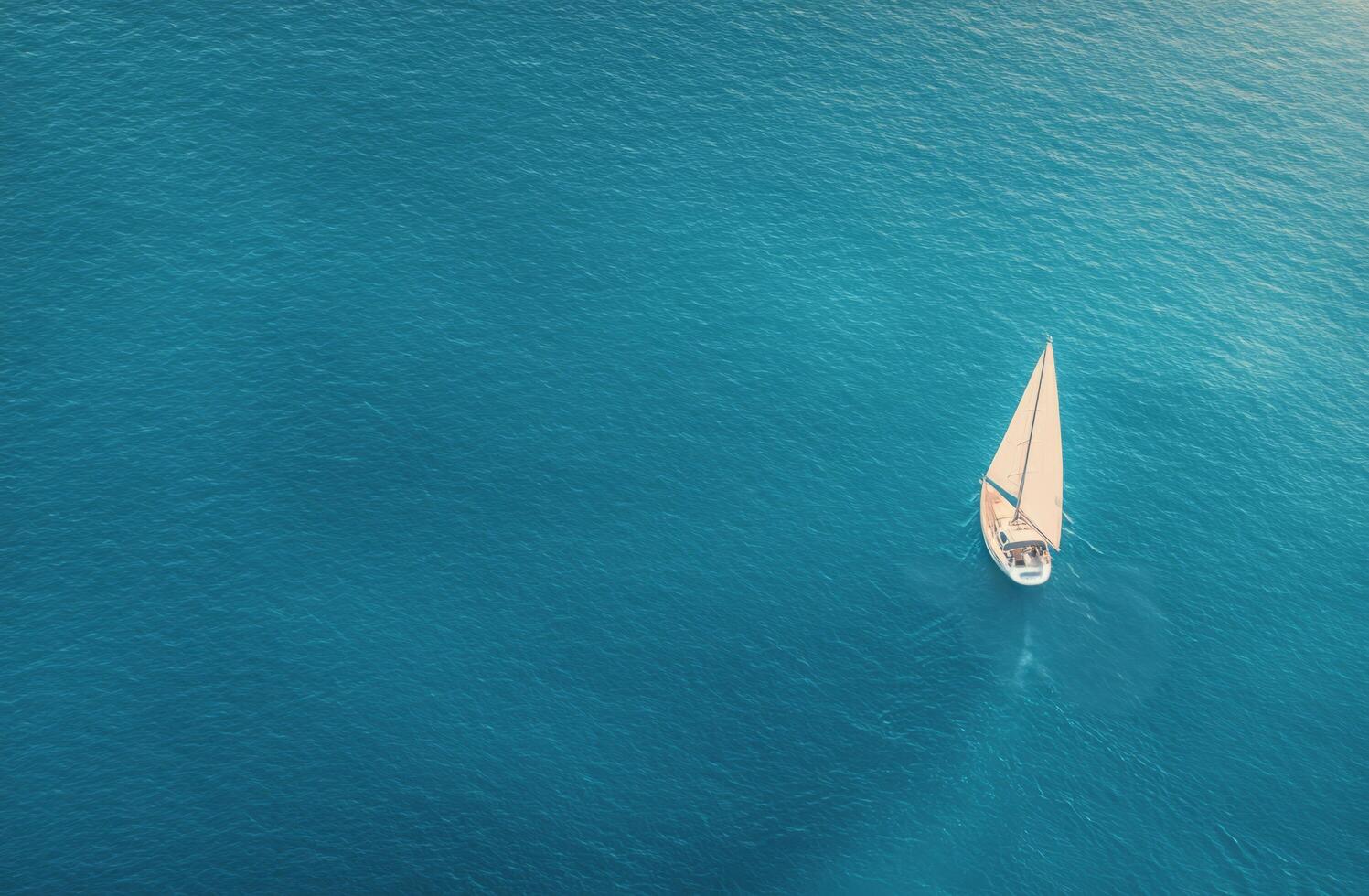 Sailing on calm blue waters with a lone boat under a sunny sky photo