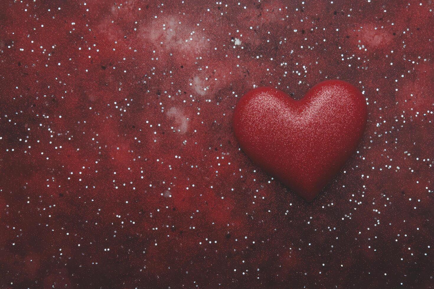 Heart shape painted on textured surface with splashes of red and white in background photo