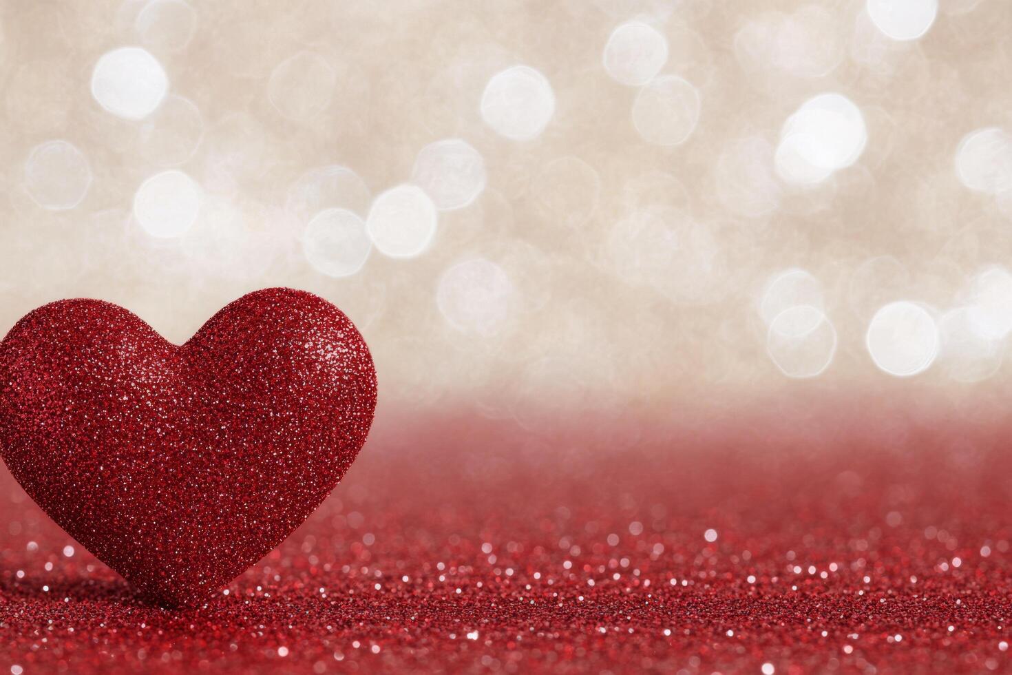 Heart shape painted on textured surface with splashes of red and white in background photo