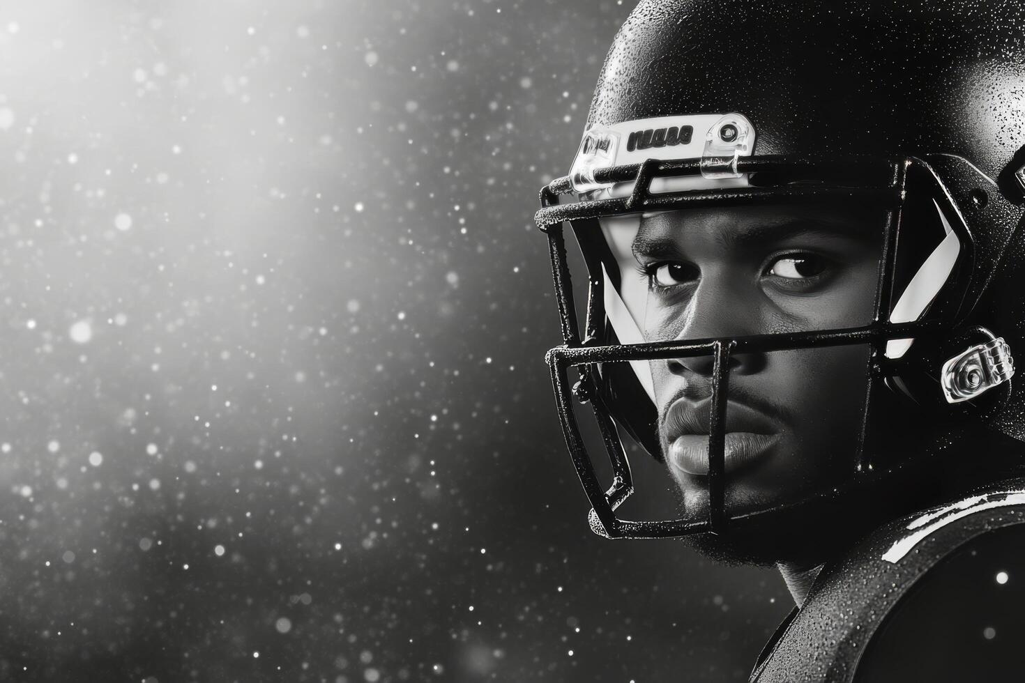 Intense football player wearing helmet and eye black during snowstorm at night photo