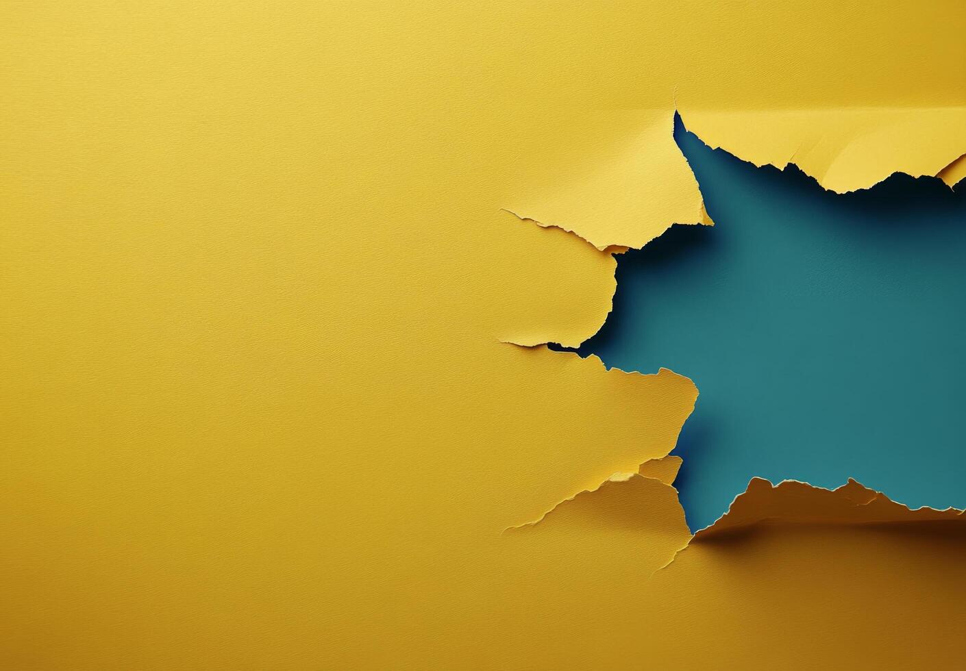 Colorful torn paper revealing a vibrant blue section against a bright yellow background photo
