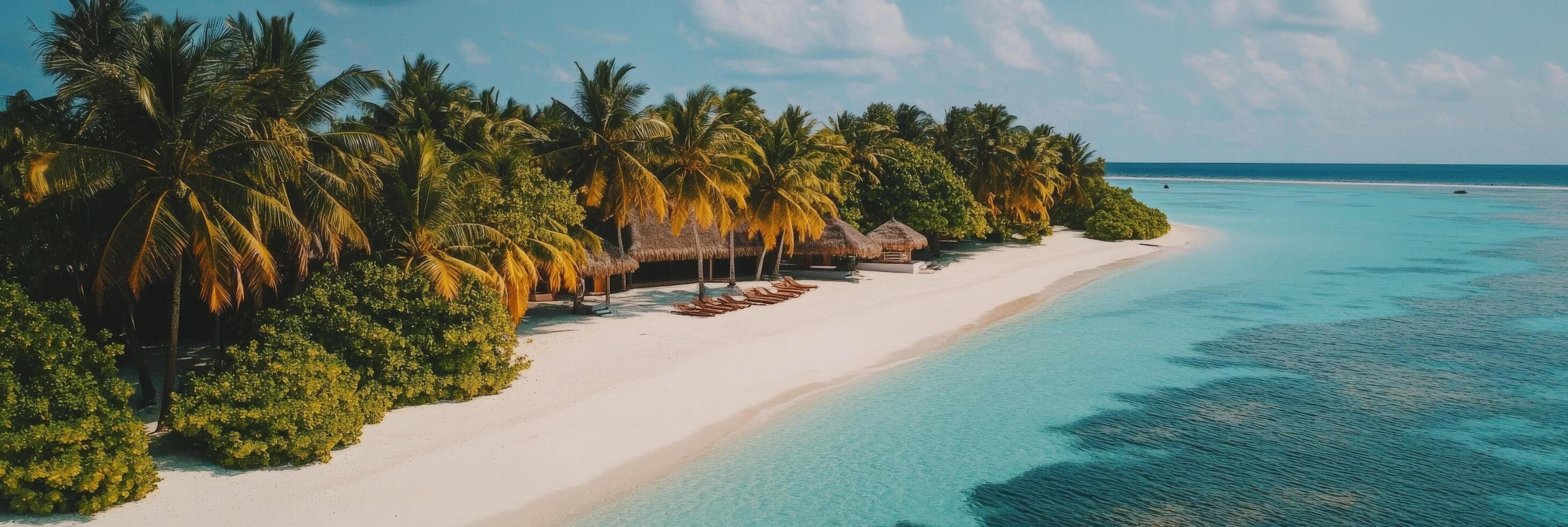 Tropical island resort with sandy beach and crystal clear water during sunny day photo
