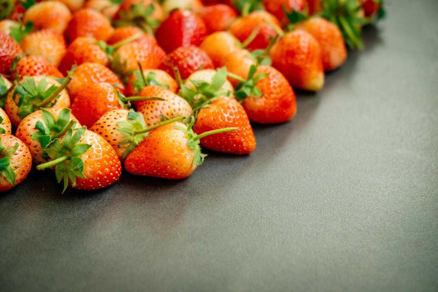 A group of strawberries are arranged in a row photo