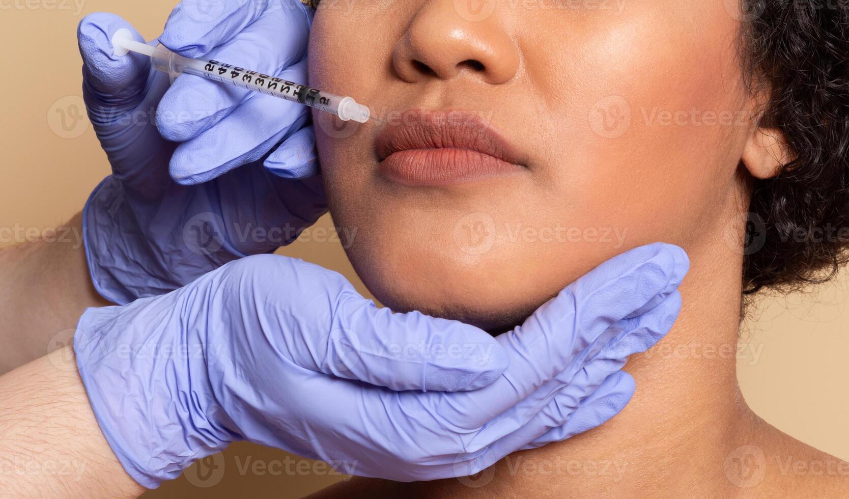 A beauty professional administers an injectable treatment to a woman's lips in a clean, bright clinic. The patient appears relaxed as the procedure is performed with care. photo