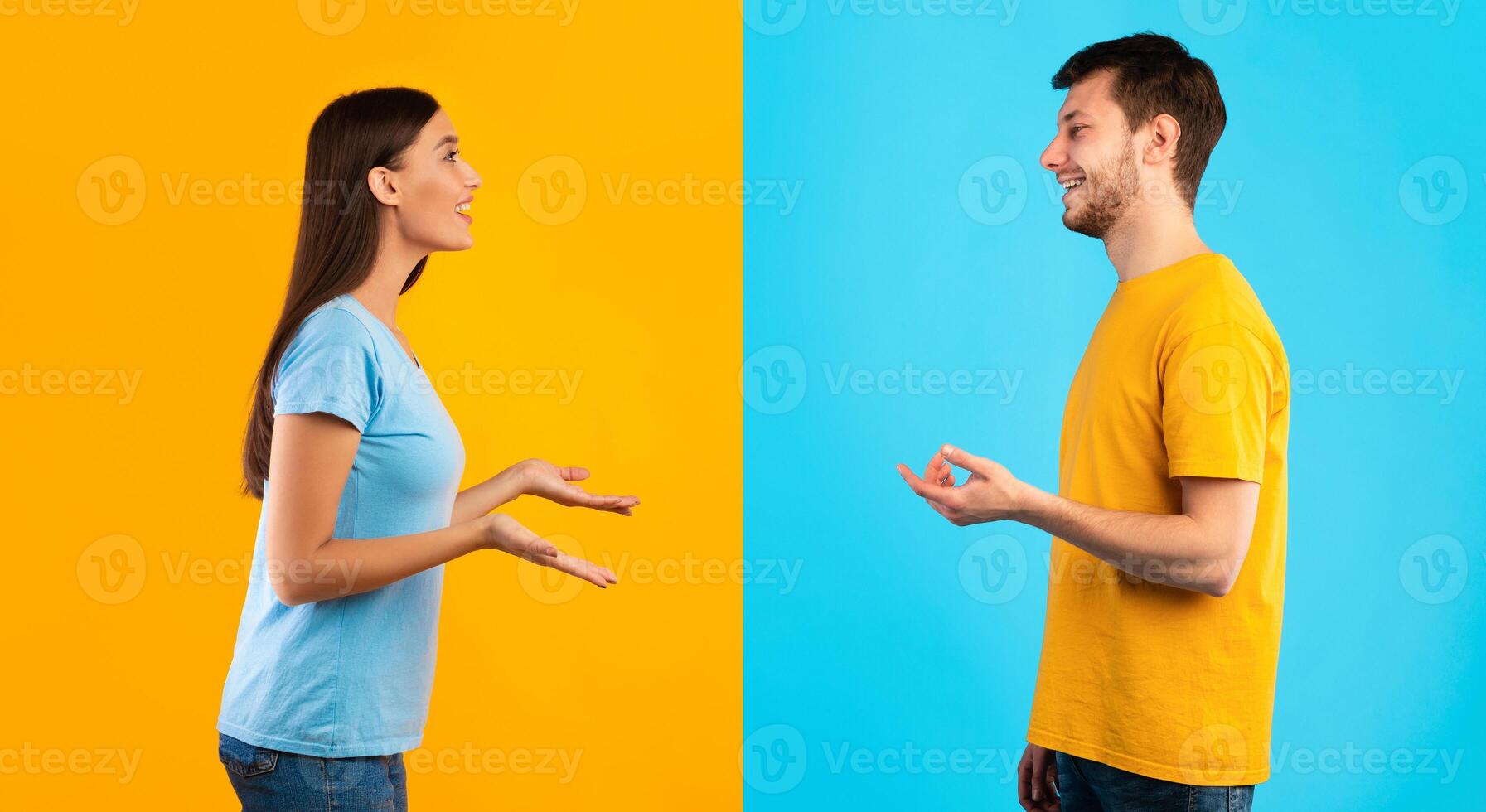 Communication. Profile portrait of casual woman and bearded smiling caucasian man talking isolated over halved blue and yellow studio background. Side view of positive couple discussing photo