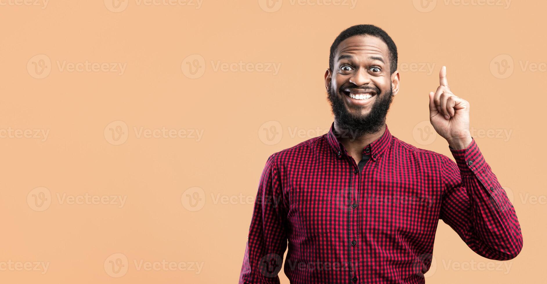Great Idea Concept. Young Funny African American Man Pointing Finger Up. Excited Black Guy Got Solution To His Problem, Having Aha Moment, Isolated On Yellow Studio Background. Wow, Eureka photo