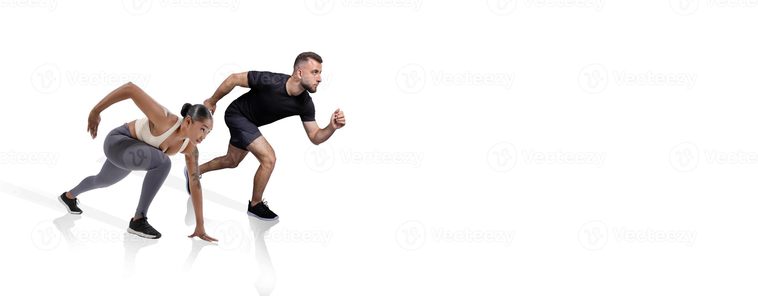 Two athletes, a woman and a man, are in an intense starting position, ready to sprint. They display determination and focus as they prepare for a fast race. photo