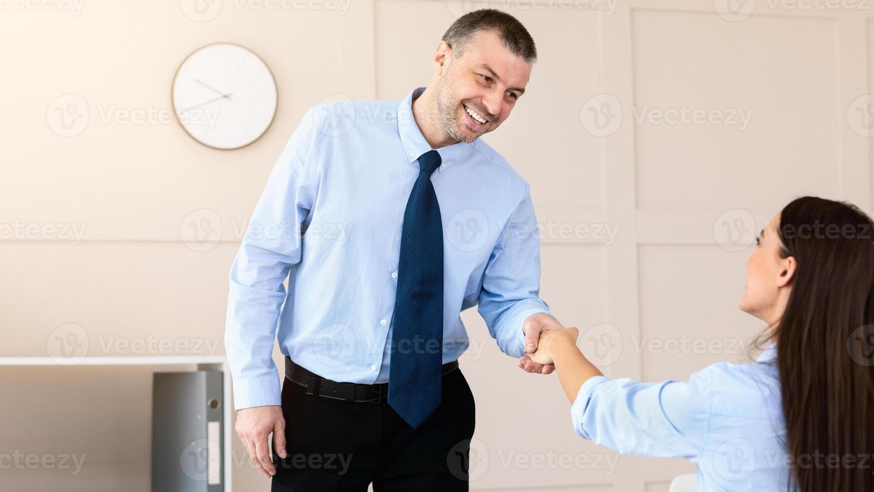 Career And Employment. Mature Man Shaking Hands With HR-Manager Lady On Job Interview In Modern Office. Selective Focus photo