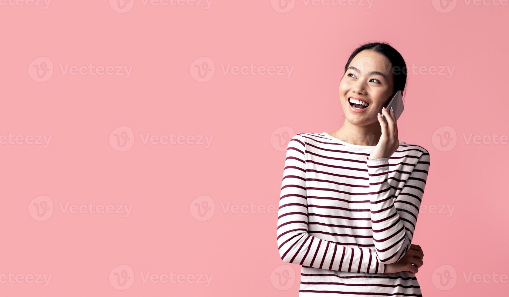 Mobile Call. Cheerful Young Asian Woman Talking On Cellphone, Joyful Excited Koren Lady Having Pleasant Phone Conversation, Enjoying Modern Communication, Standing Over Pink Background, Copy Space photo