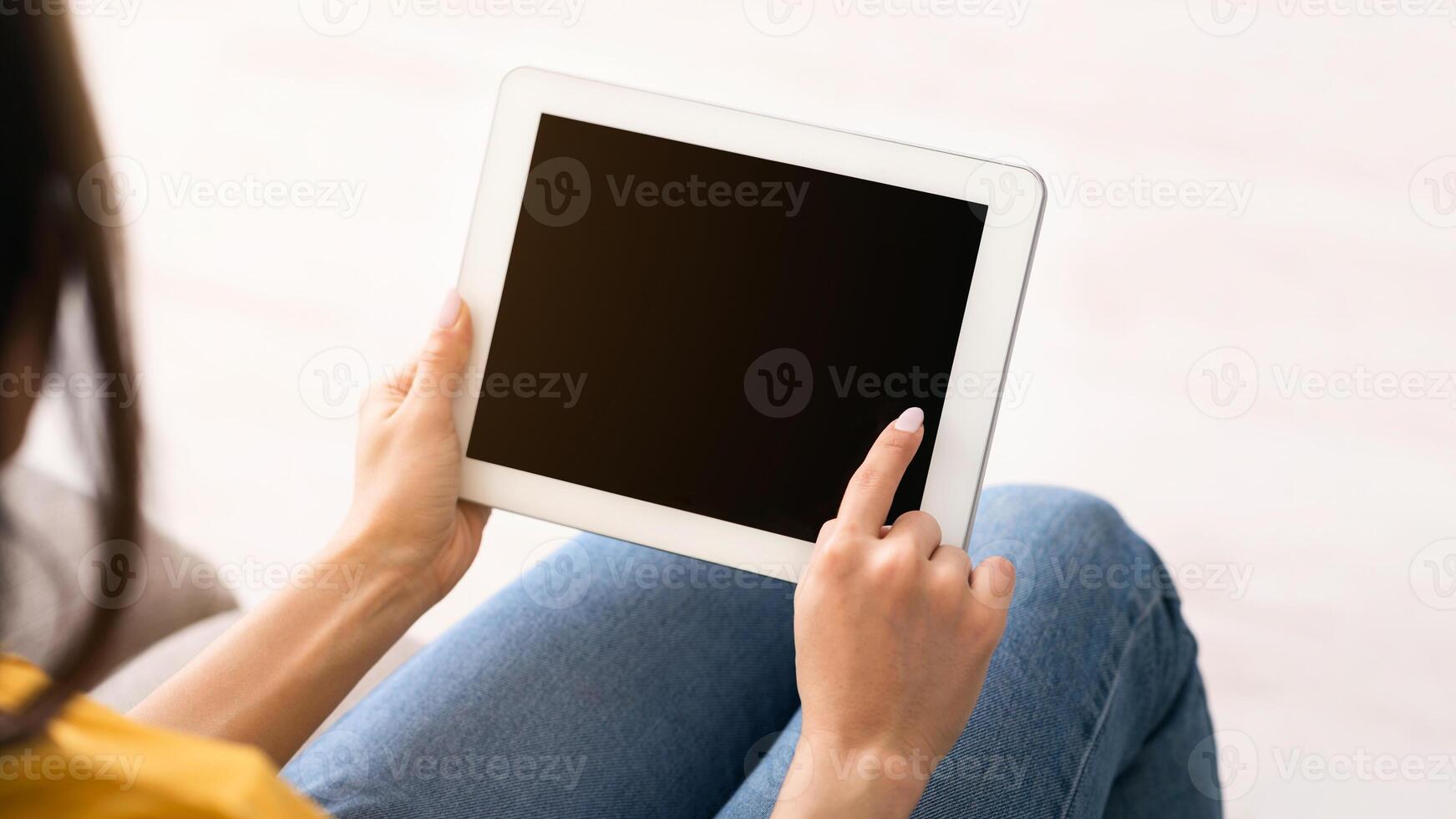 Stay home, chat online. Unrecognizable girl holding tablet computer with empty screen indoors, space for design photo