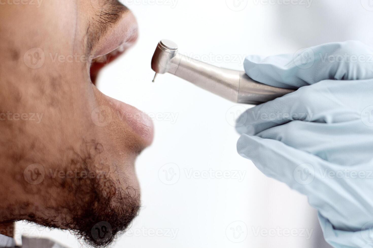Dental Treatment. Dentist Woman Using Dental Drill For Black Male Patient In Clinic, Young African American Man Sitting With Opened Mouth, Enjoying Professional Stomatologic Services, Closeup photo