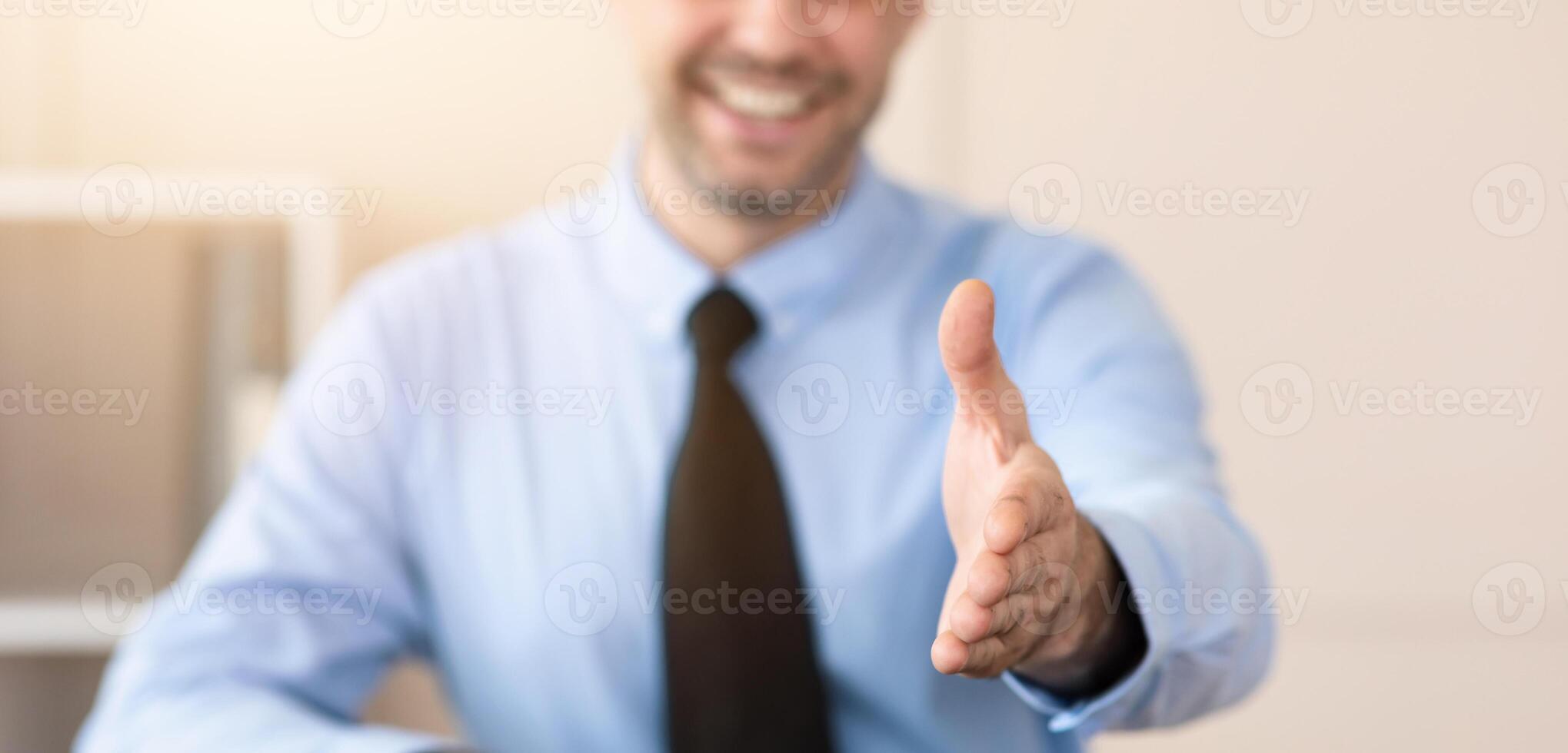 Partnership Concept. Businessman Stretching Hand For Handshake Greeting During Job Interview Sitting In Modern Office. Selective Focus photo