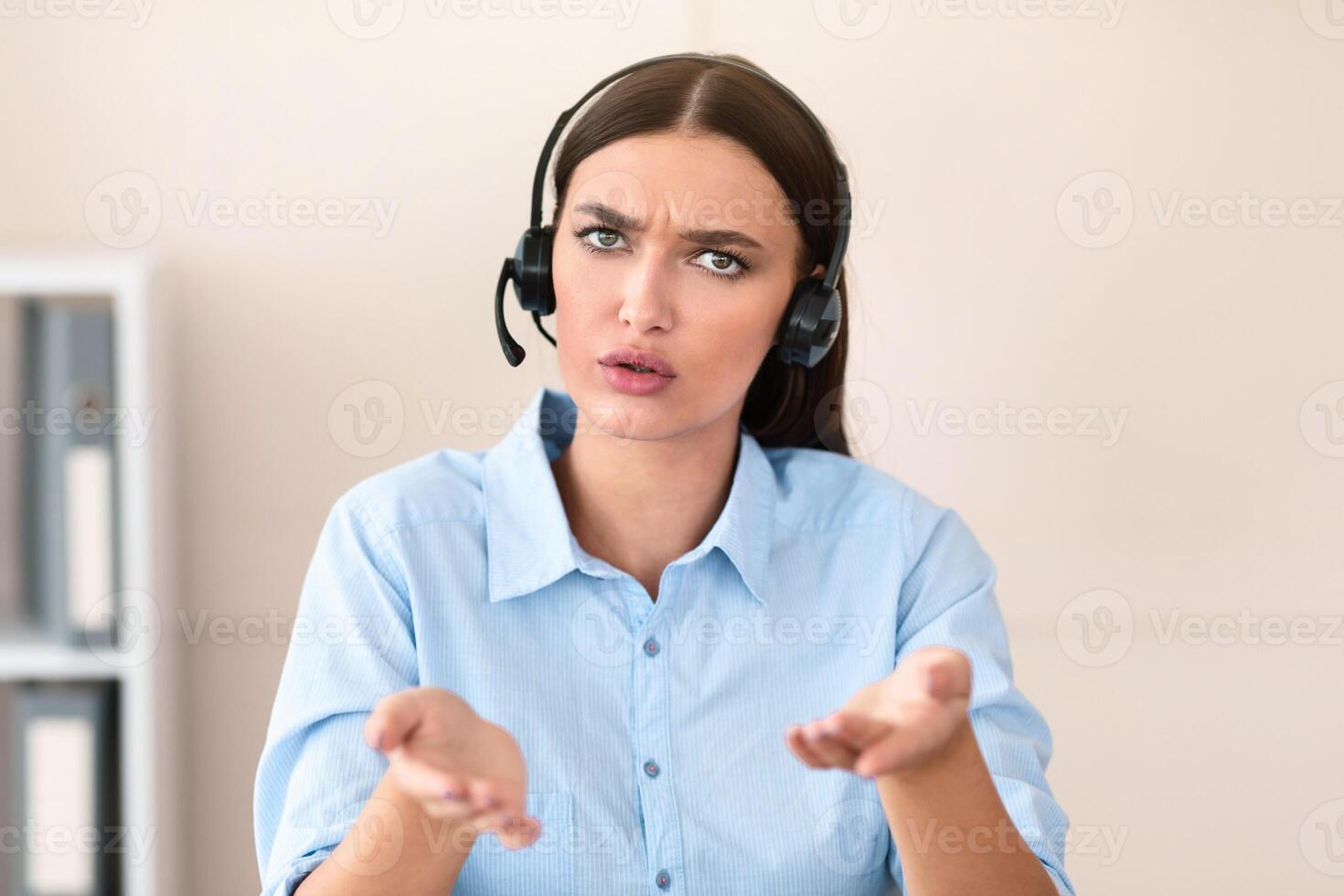 Hotline Service Concept. Call Center Worker Girl Talking With Discontented Customer Consulting And Solving Problem Sitting In Office, Wearing Headset. photo