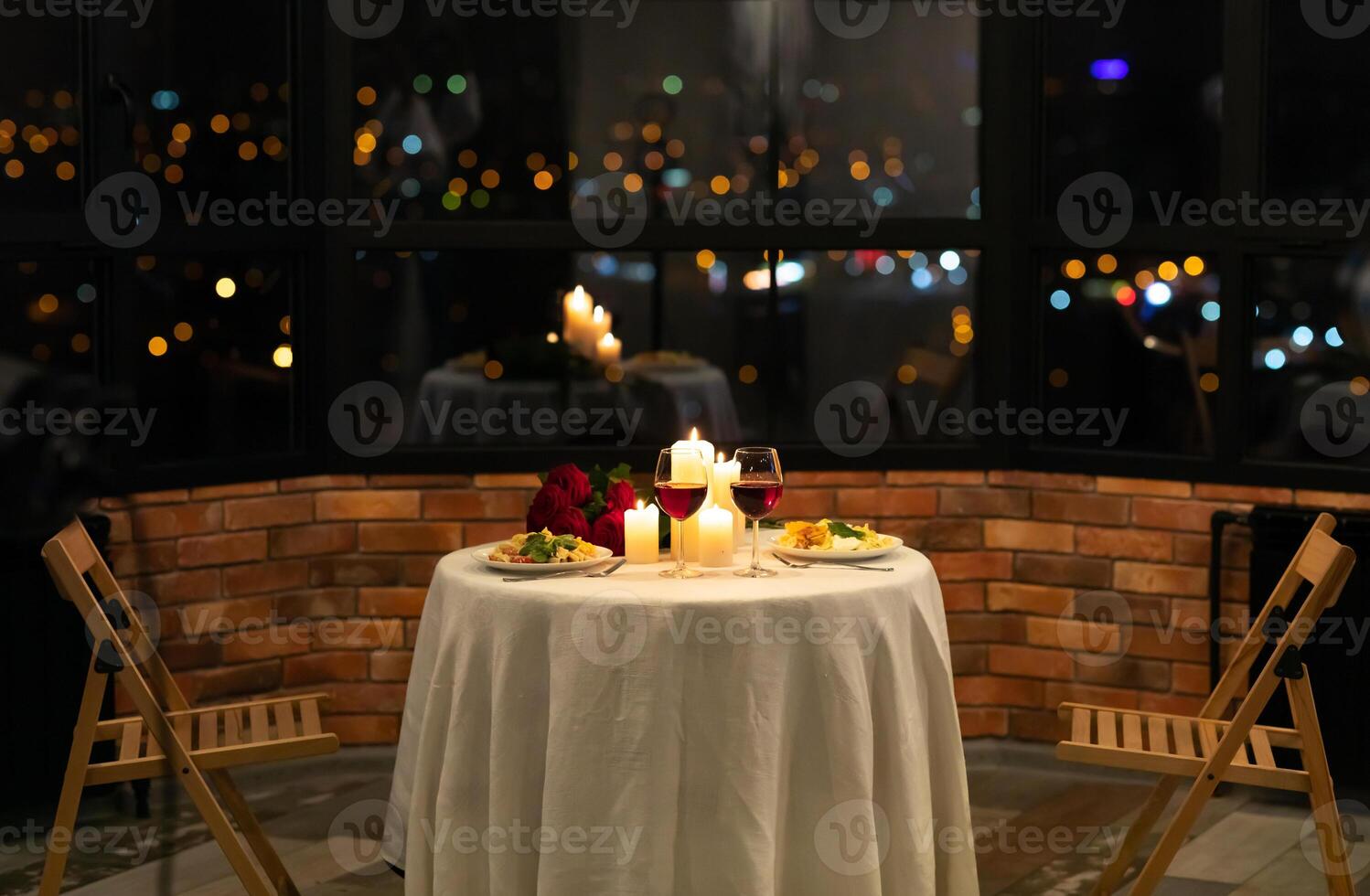 Romantic Date Dinner Concept. Served Table With Food And Burning Candles In Restaurant Interior At Night. No People photo