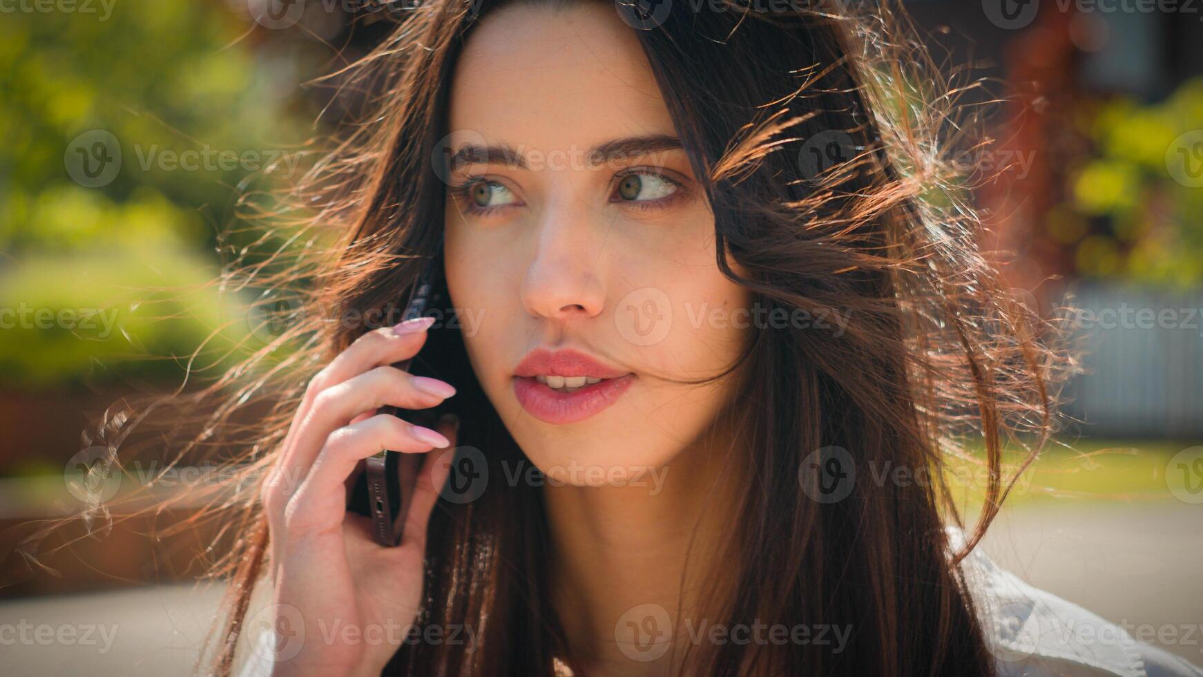 Close-up woman businesswoman student talking on mobile phone outdoors girl client remote make order using smartphone on street speak friend answering business call talk on cellphone female portrait photo