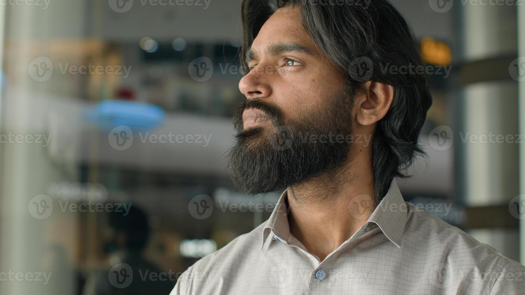 Close-up ethnicity male face serious pensive bearded indian man guy ethnic businessman customer looking at camera gaze with brown eyes client ophthalmology clinic good healthy vision medical procedure photo