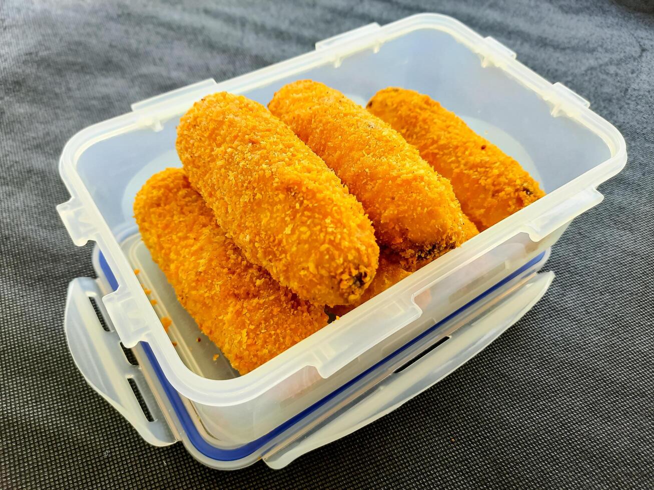 Crispy Fried Bananas in a Plastic Container photo
