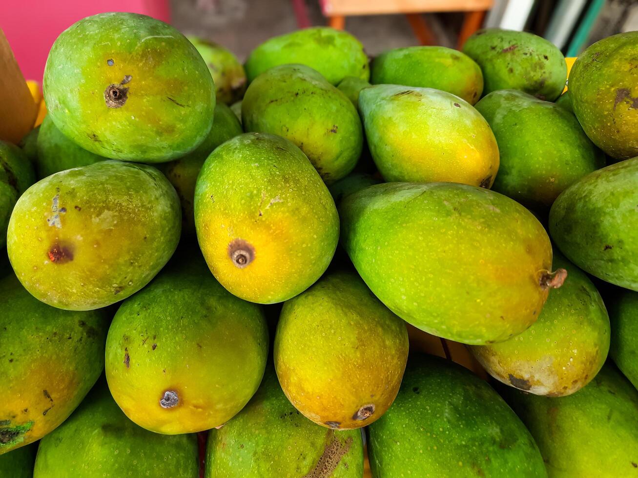Fresh Green Mangoes Displayed in a Market photo