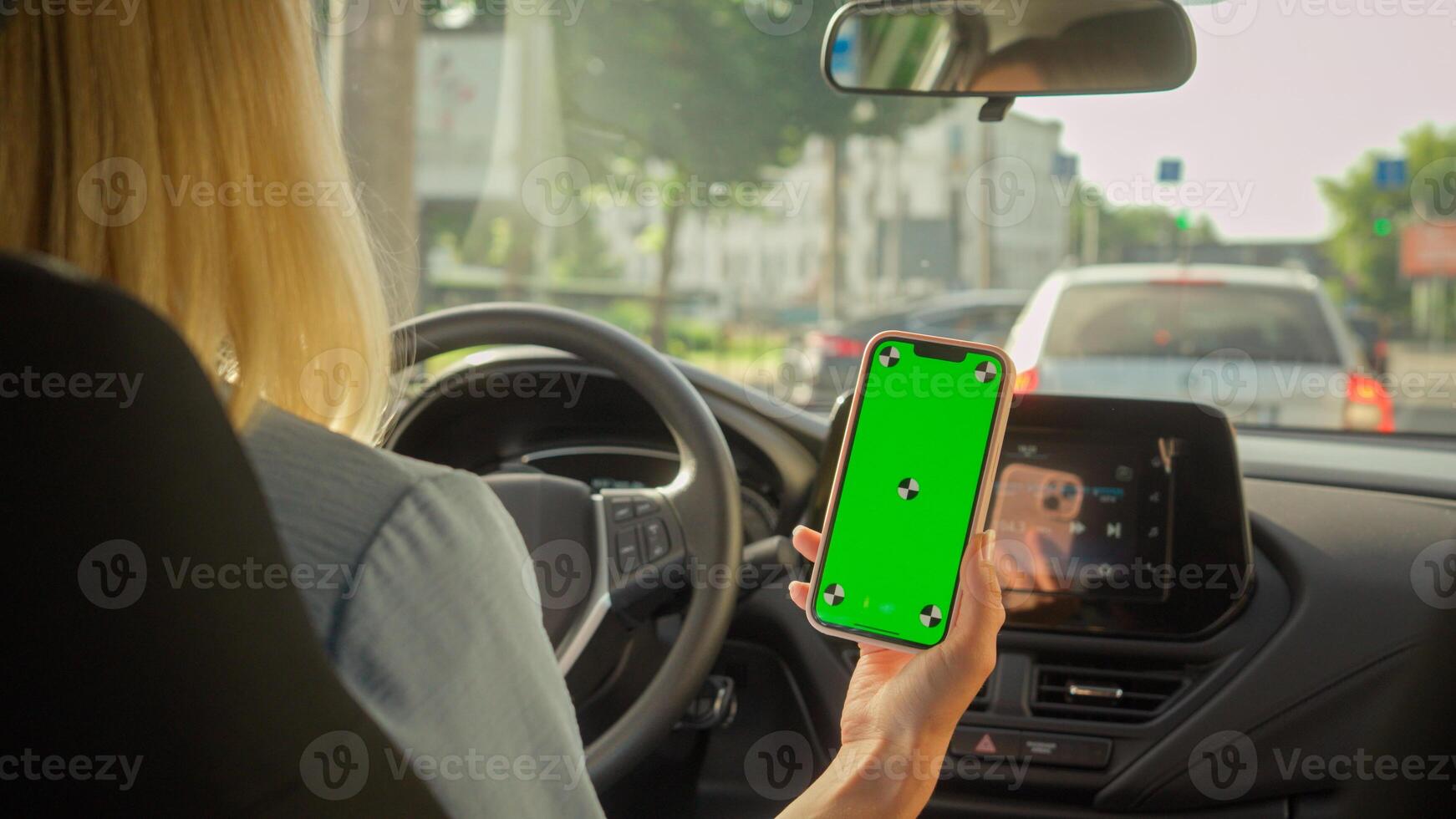 Unrecognizable Caucasian businesswoman girl driving car driver female steering wheel transportation in city auto buyer woman looking mobile phone green screen gps navigator app automobile vehicle rent photo