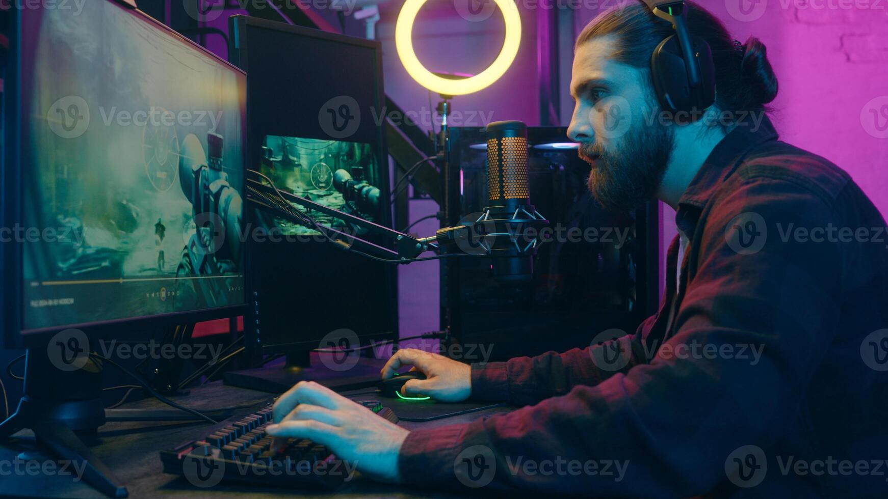 Happy Caucasian gamer addict man guy influencer streamer playing virtual pc game cyber sport at home two monitors computer. Focused male player blogger speak microphone device blog radio stream vlog photo