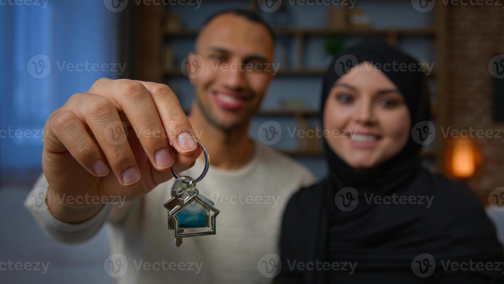 Happy owners property multiracial family spouses ethnic couple showing bunch of keys new home relocation homeowners african american man muslim woman rent flat buy dream house apartment loan mortgage photo