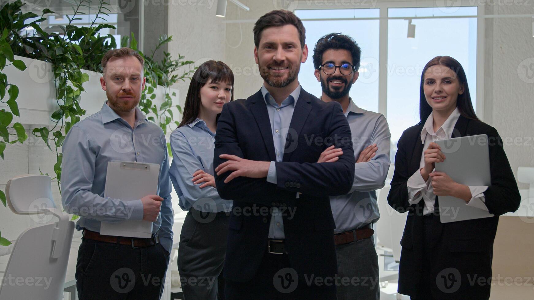 Portrait man confident CEO leader chief boss crossed arms posing in corporate office company leadership with professional multiracial businessmen and businesswomen happy business team colleagues smile photo