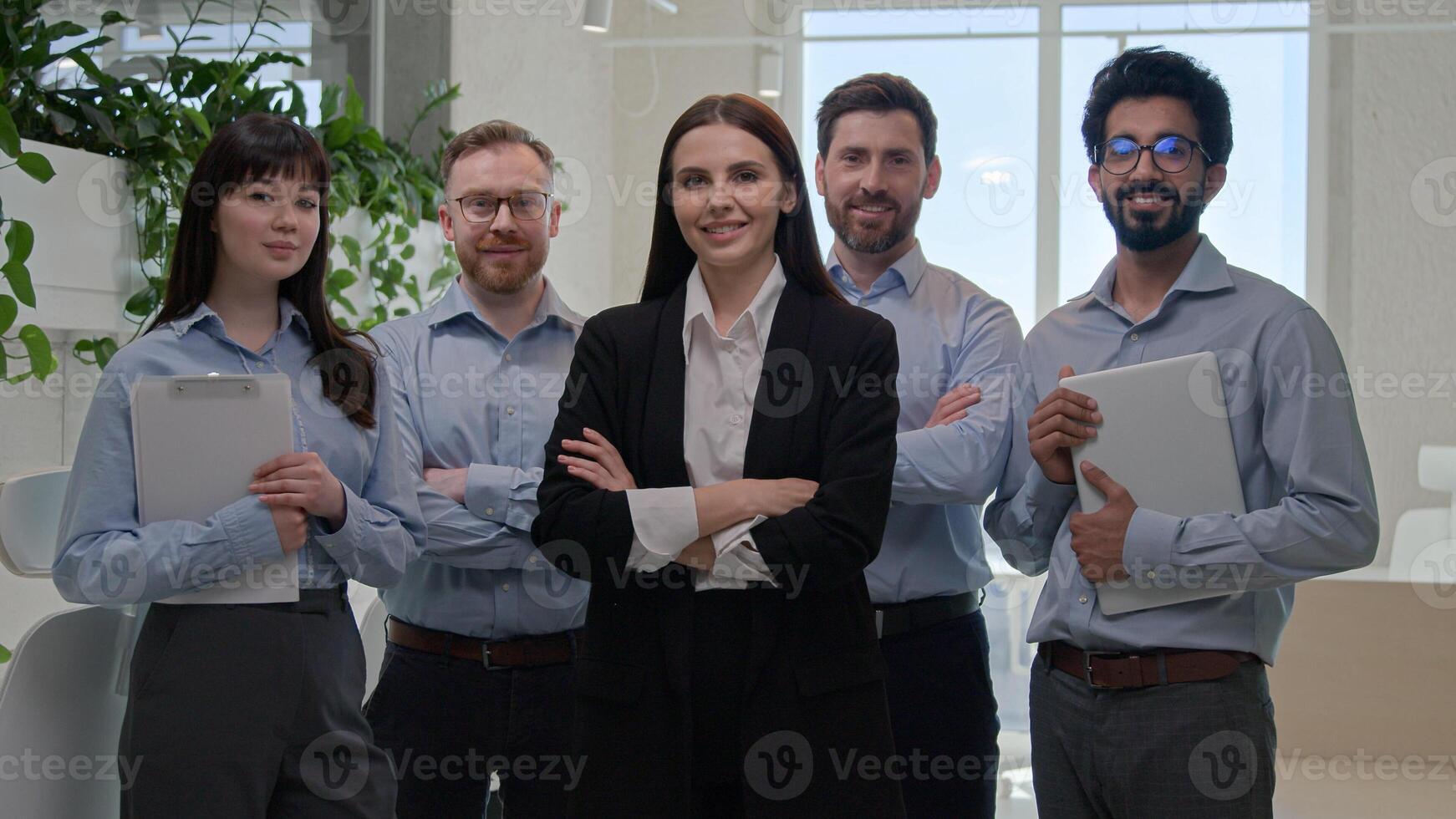 Happy multiethnic business people with professional team leader businesswoman group portrait diverse colleagues employees co-workers businessmen and businesswomen smiling pose crossed hands in office photo