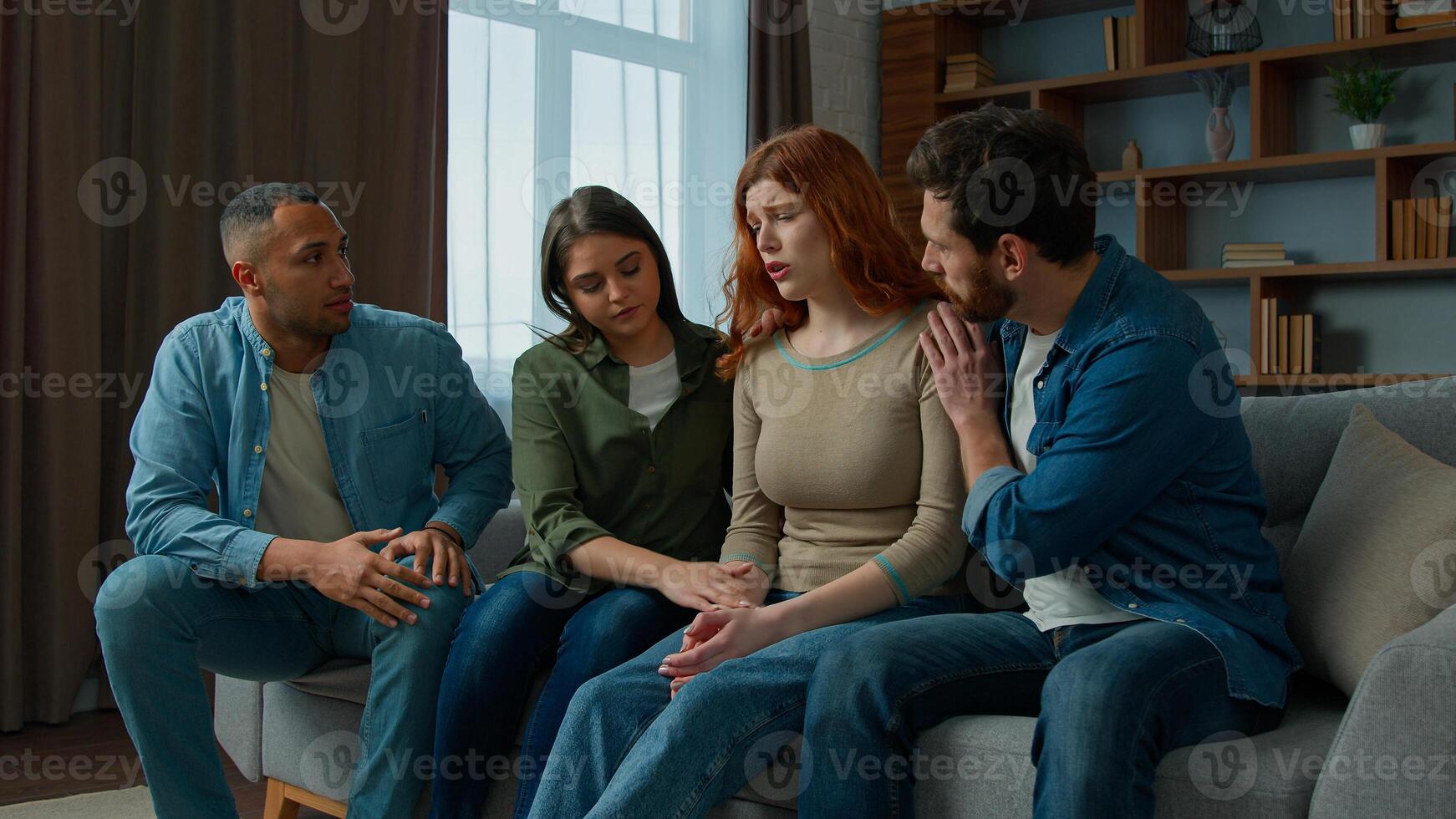 Sad desperate girl talk share problem with friends in group psychological therapy at home diverse ethnic women men help upset girl. Caring multiracial teammates listen complaints support give advice photo