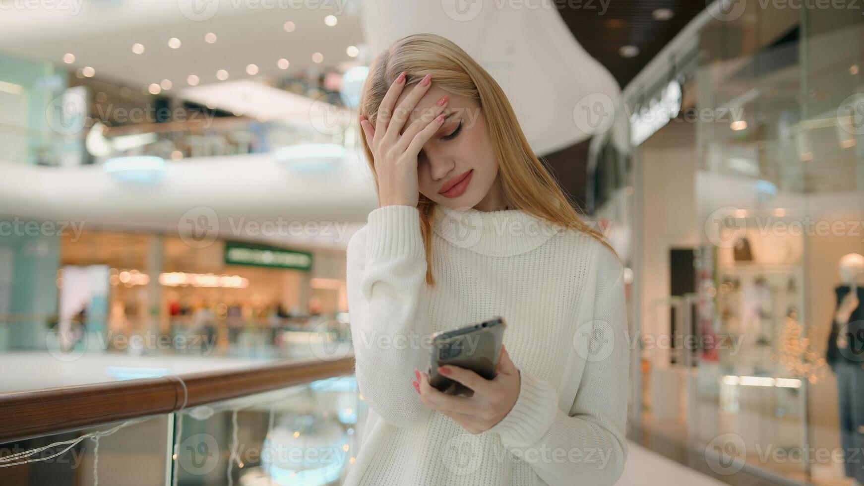 Sad Caucasian puzzled anxious female businesswoman 25s woman has problem with smartphone receive bad message on mobile phone low public internet connection upset dissatisfied girl lady express despair photo