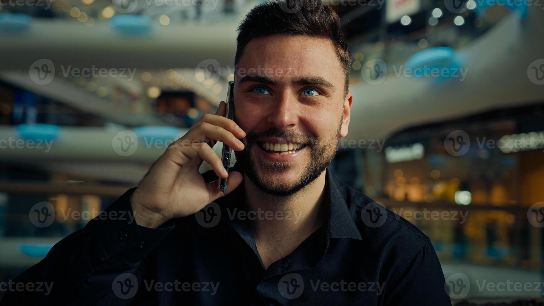 Smiling entrepreneur caucasian hispanic businessman 30s man employer boss salesman talk mobile phone distant negotiate consult client business call online communication with client smartphone converse photo