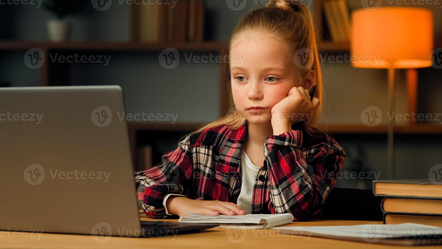 Weary sleepy caucasian young child blonde little lazy tired girl studying routine online elementary educational lesson on laptop napping at home feeling boredom chronic burnout fatigue after computer photo