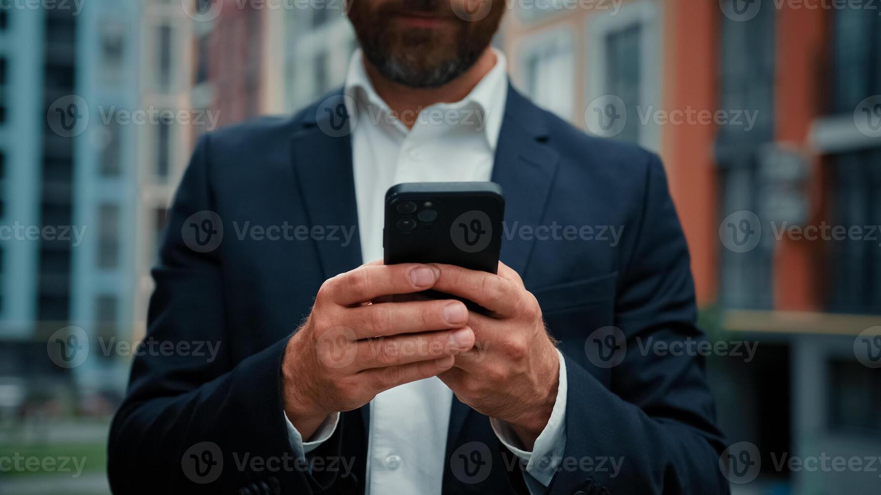 Businessman unknown man stand in city hold phone gadget send messages virtual communication make order online read digital news search media content shopping at internet store use mobile banking apps photo