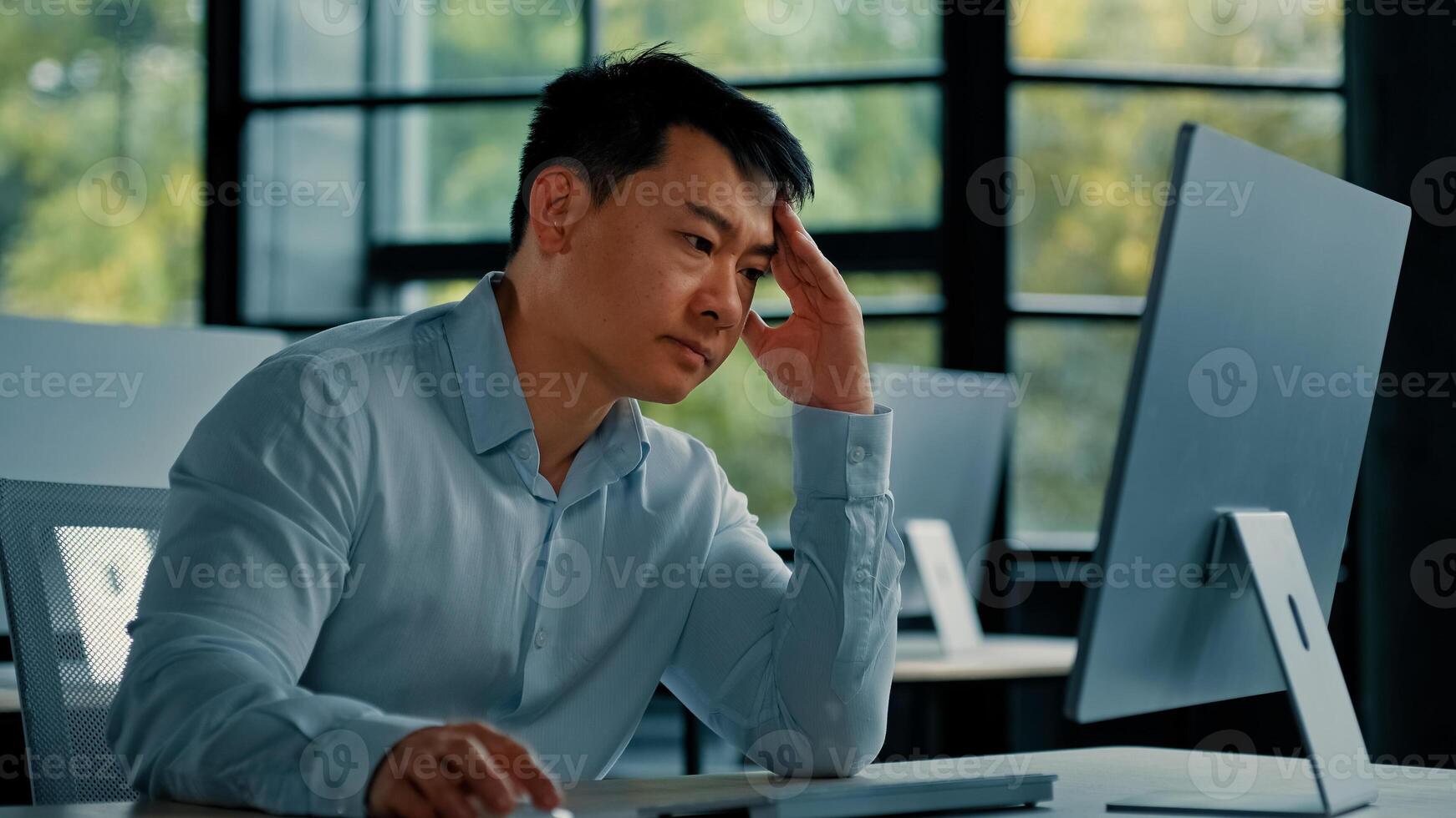 Asian businessman korean man work online at workplace difficult hard job get incorrect error in computer failure business problem. Upset anxious male disappointed about mistake bad internet in office photo