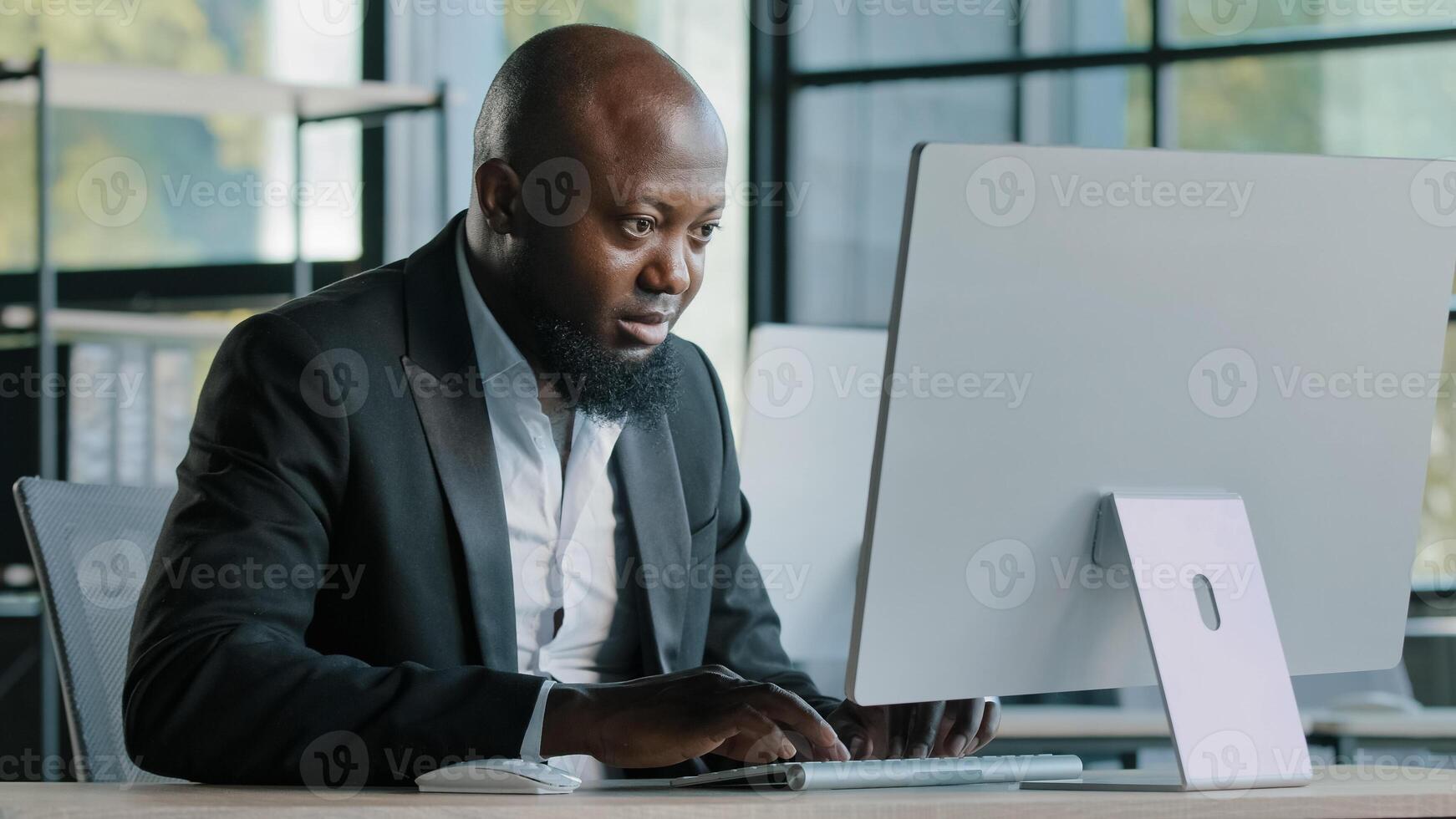 Professional man worker african american 40s businessman millennial ethnic male salesman develop online project work on personal computer in modern office company coding business program ecommerce job photo