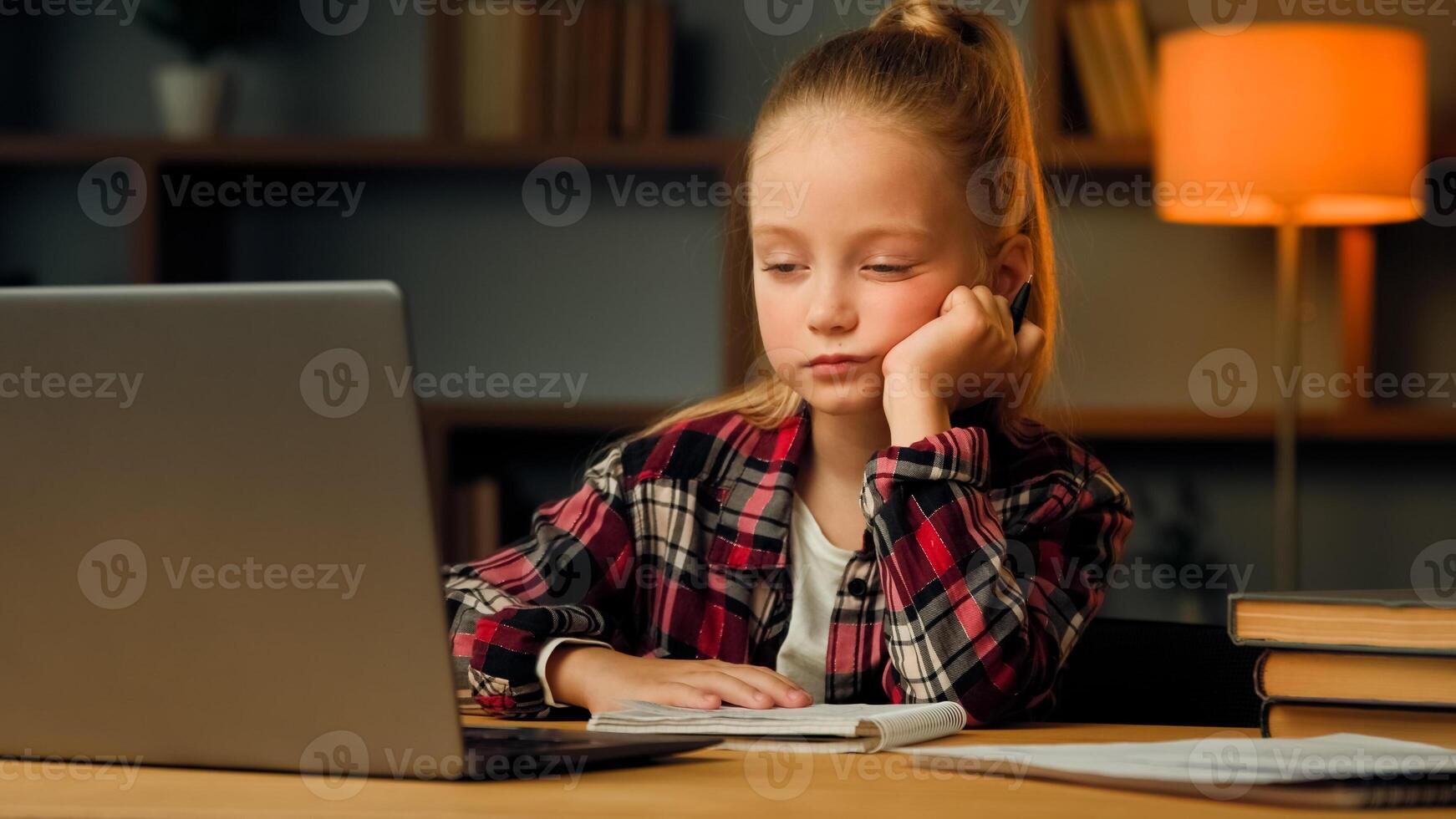 Weary sleepy caucasian young child blonde little lazy tired girl studying routine online elementary educational lesson on laptop napping at home feeling boredom chronic burnout fatigue after computer photo