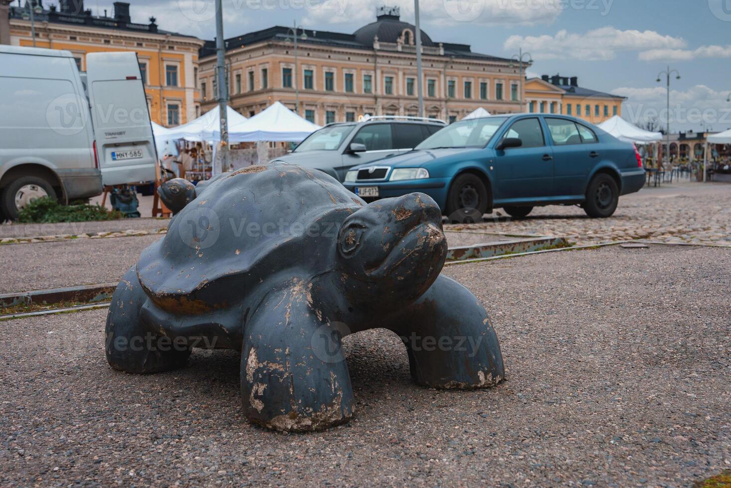 Weathered Turtle Sculpture in Helsinki Public Square with Market photo