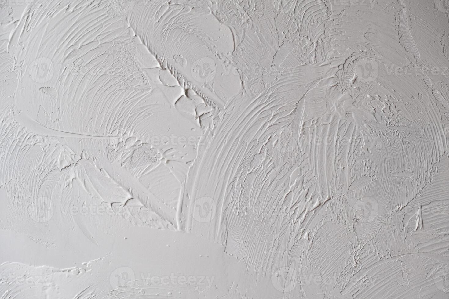 Applying decorative putty. White abstract texture of surface covered with putty photo