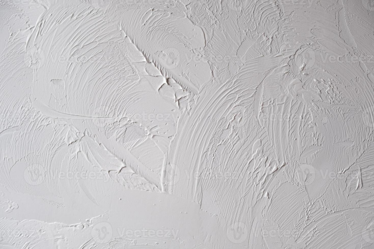 Applying decorative putty. White abstract texture of surface covered with putty photo
