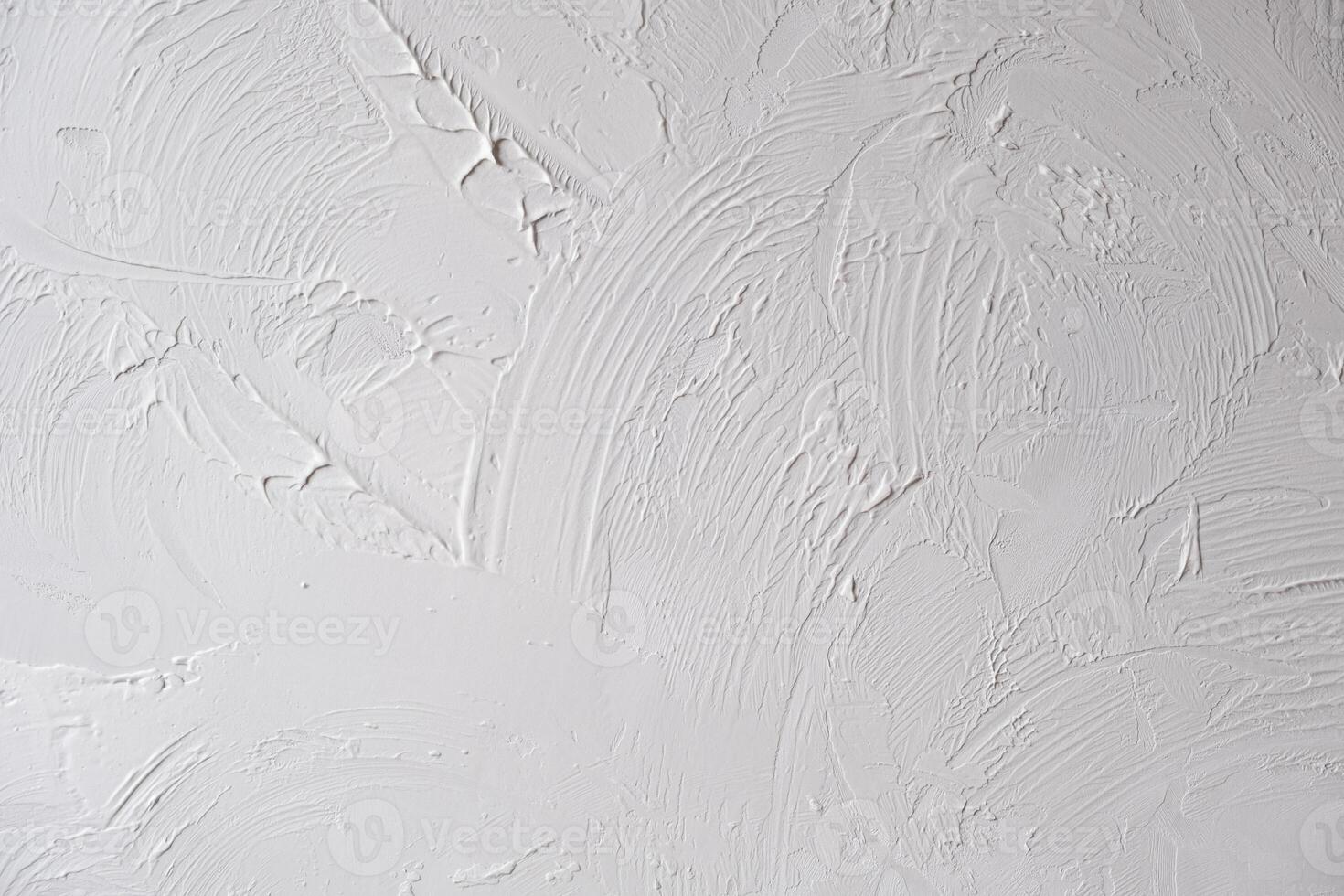 Applying decorative putty. White abstract texture of surface covered with putty photo