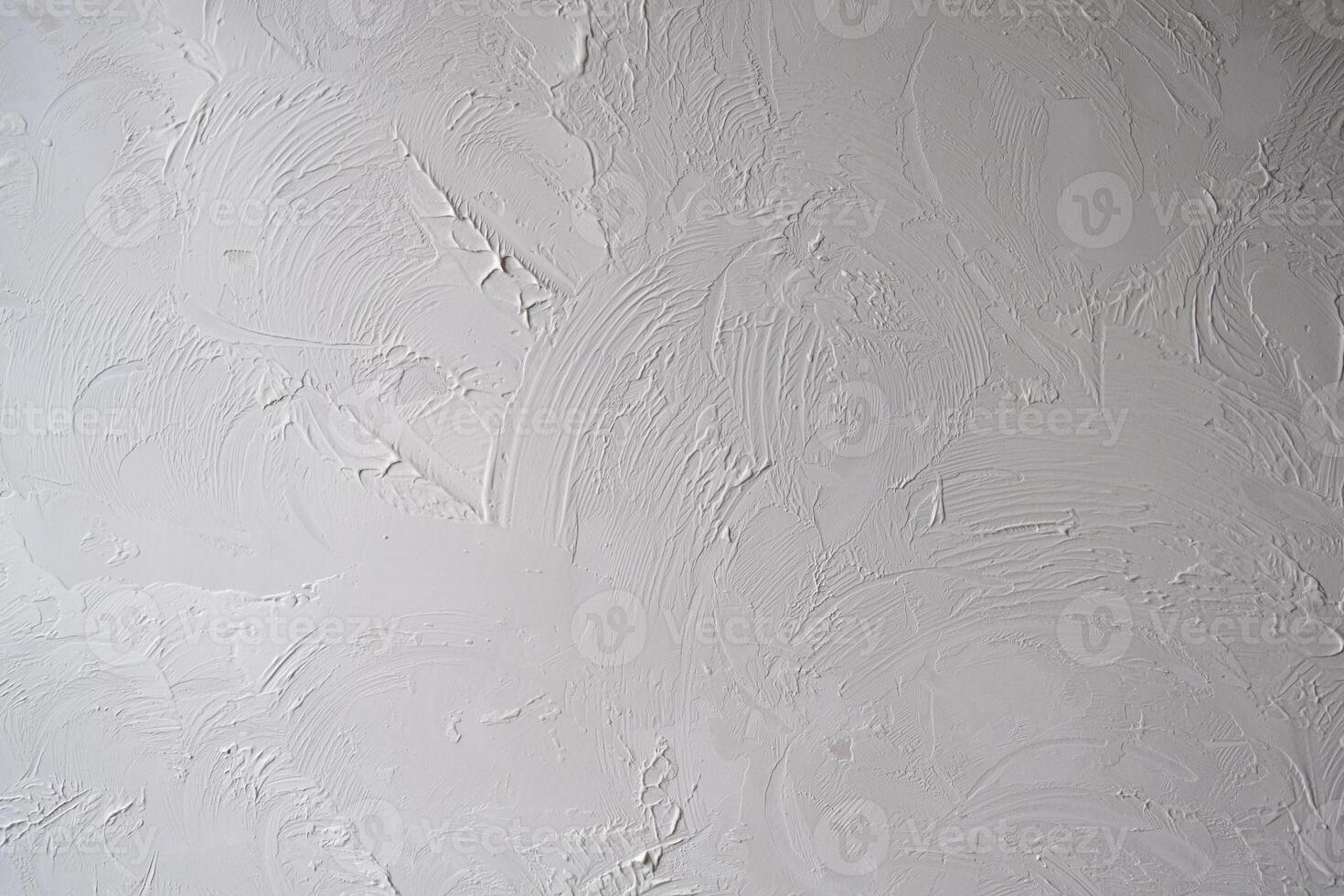 Applying decorative putty. White abstract texture of surface covered with putty photo