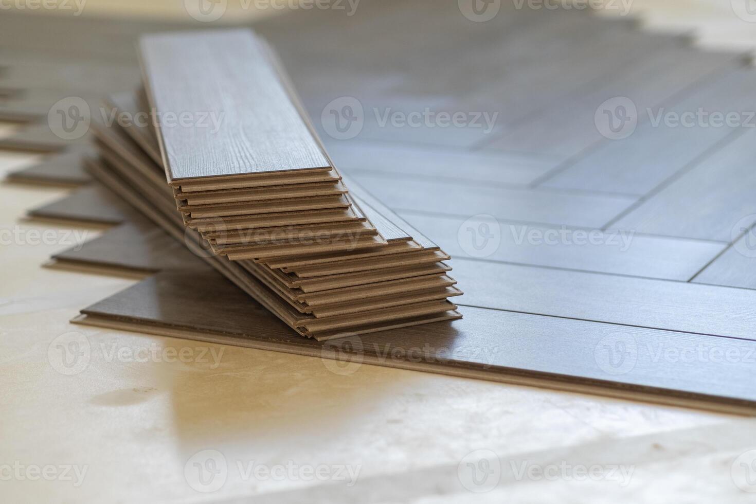 Close-up of laminate flooring installation in a modern apartment. Worker placing photo