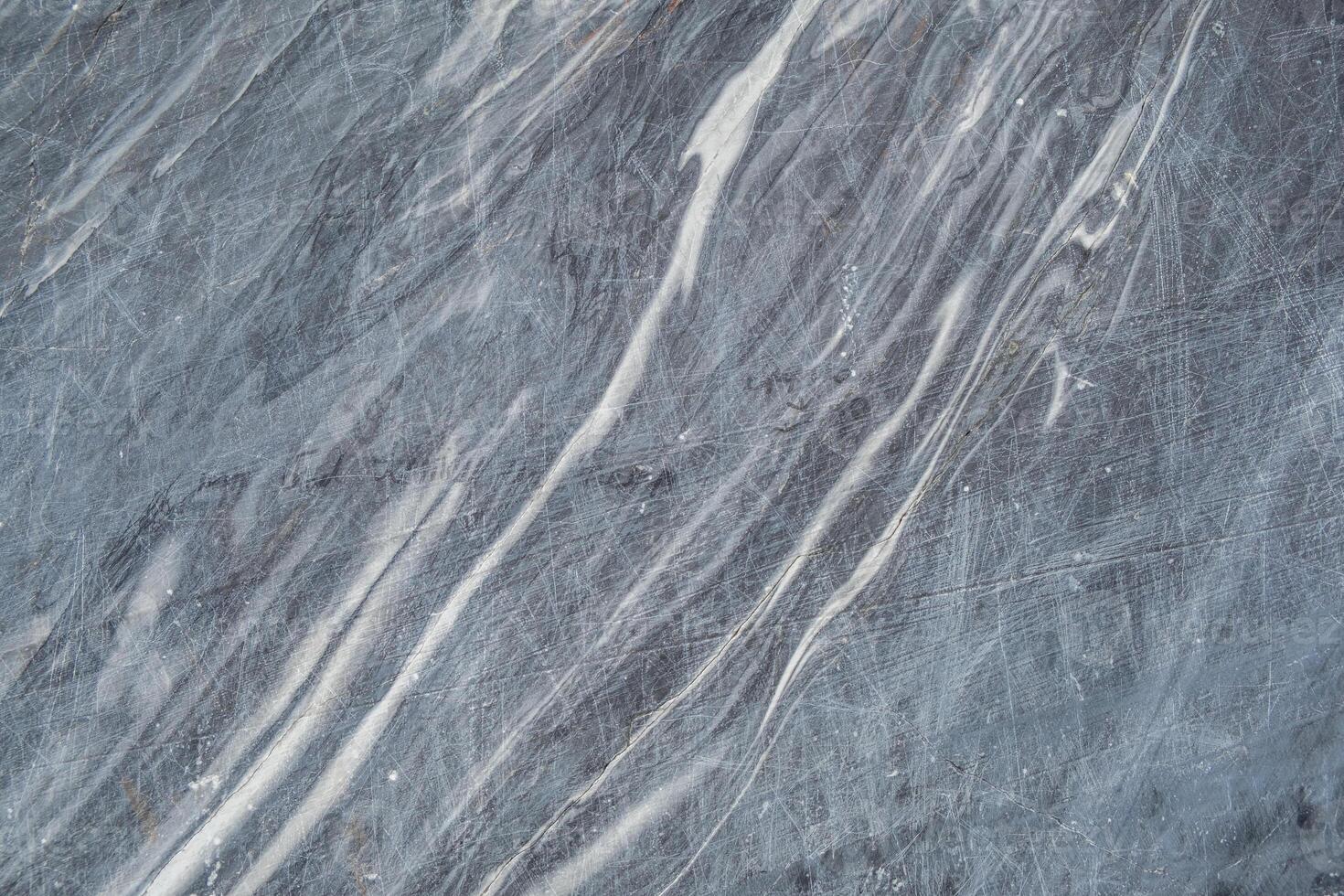 This gray marble features beautiful white veining, highlighting its natural patterns and ideal use for elegant surfaces and decor photo