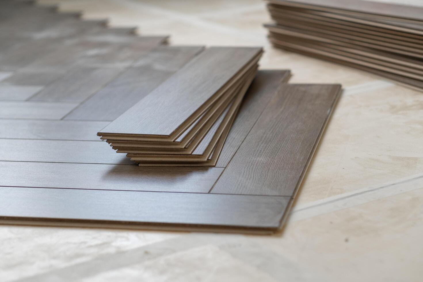 Laminate floor installation in a modern apartment, showing tools, planks photo