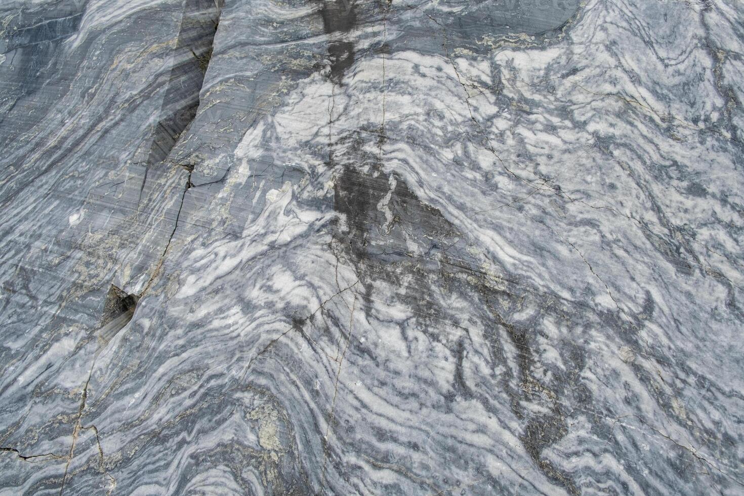 A detailed close-up reveals the unique swirls and veins of gray marble, highlighting its natural beauty and intricate patterns suitable for design photo