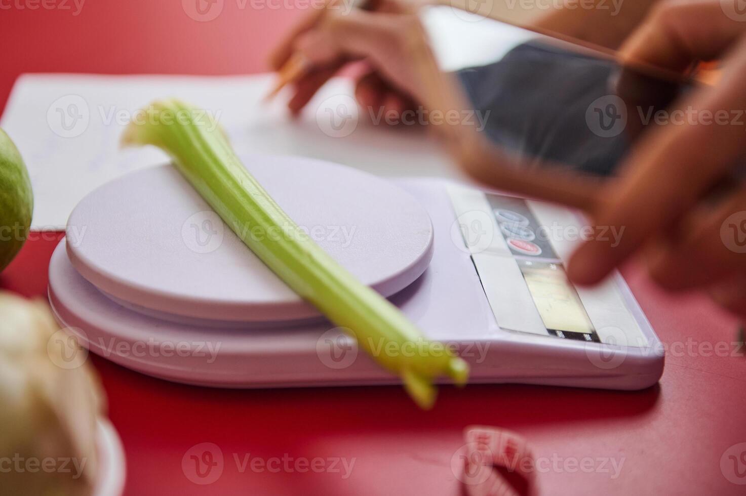 Celery on digital scale with focus on healthy eating photo