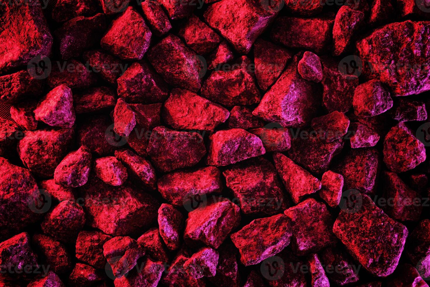 Trending space minimal neon red background with stones. Asteroid or comet stones in fluorescent creative lighting. photo