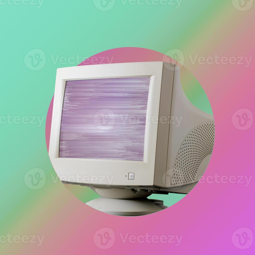On velvet purple and green background is retro monitor with glitch on screen. photo